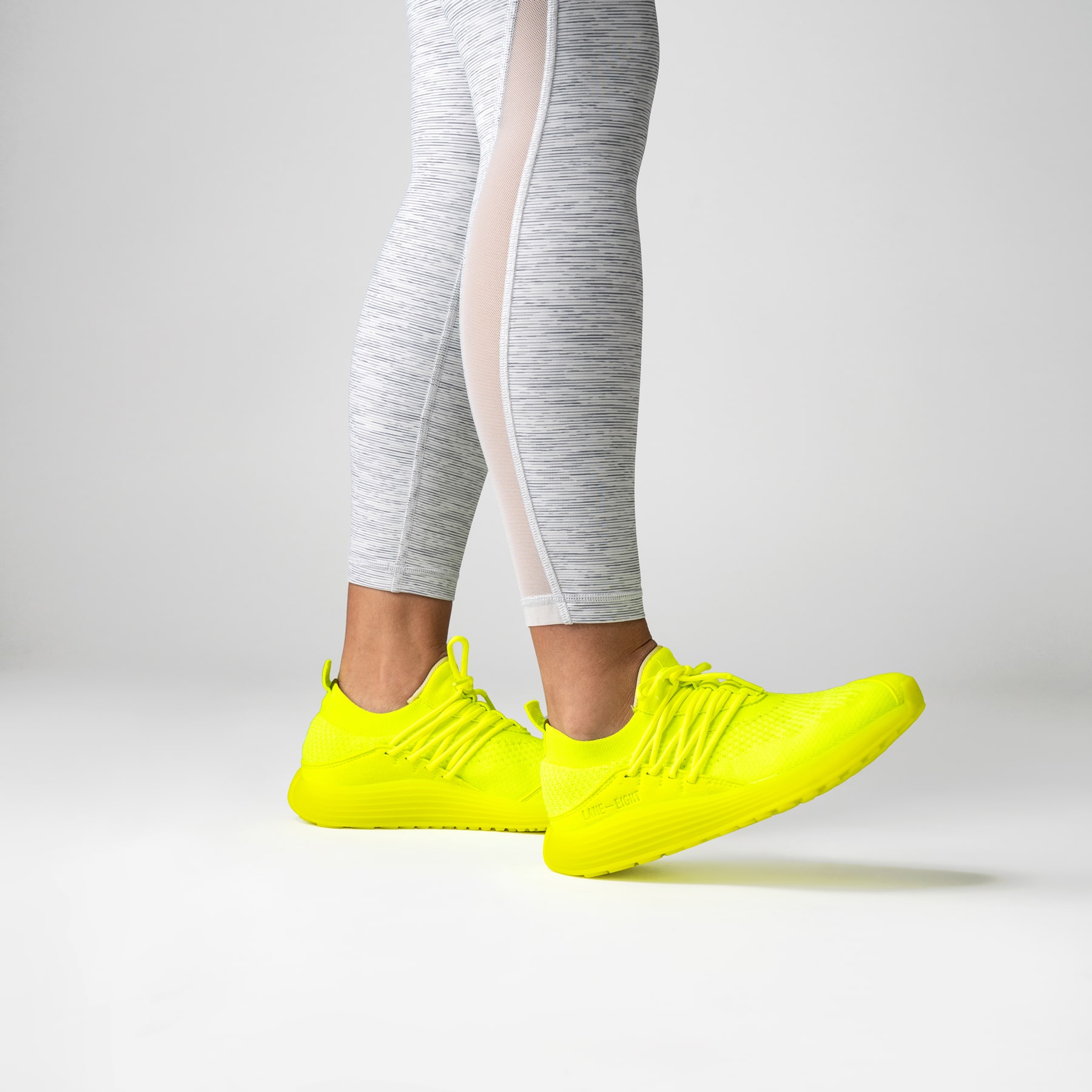 LANEEIGHT-TRAINER-AD-1-ElectricNeon-WomensOnFoot-min