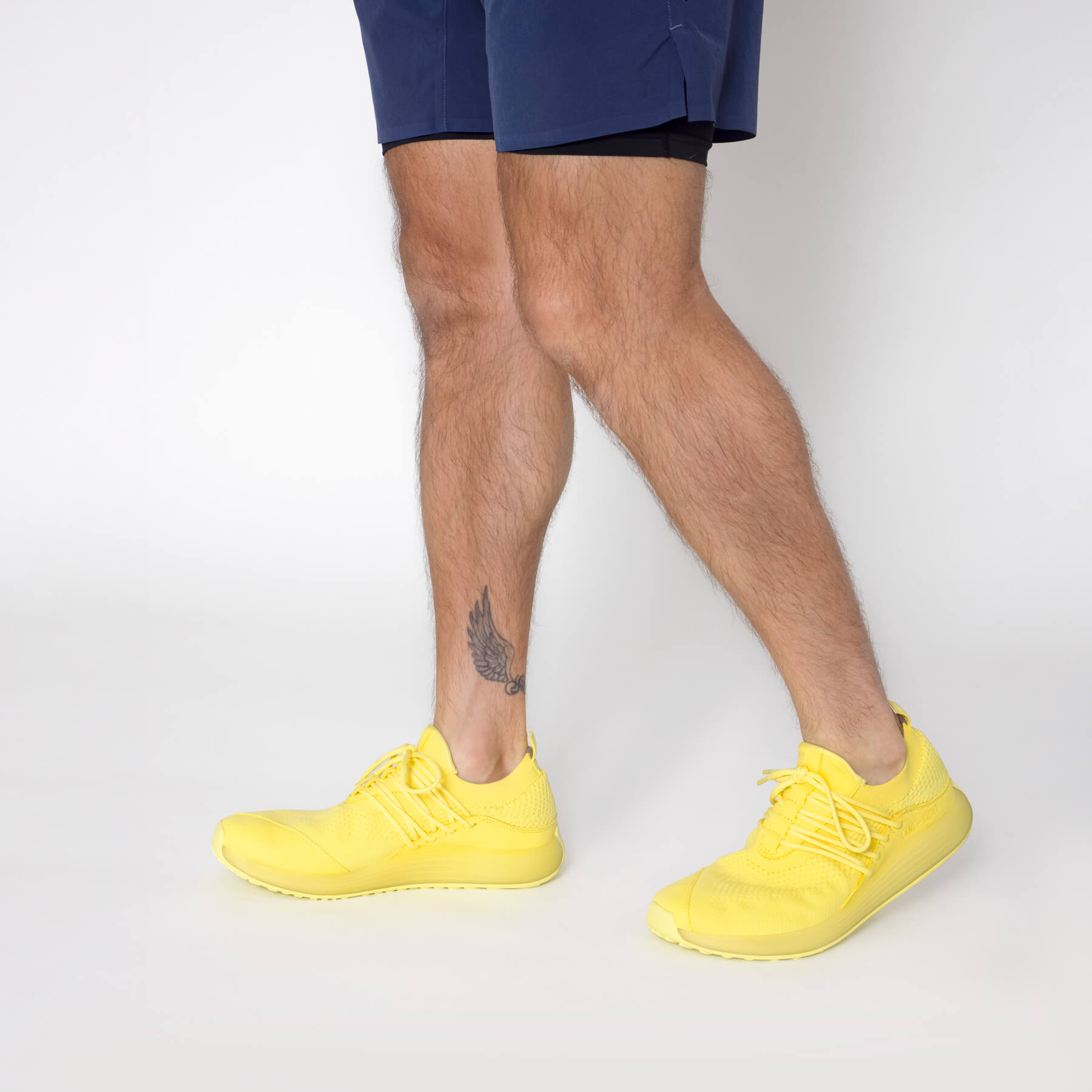 LANEEIGHT-TRAINER-AD-1-SunriseYellow-MensOnFoot